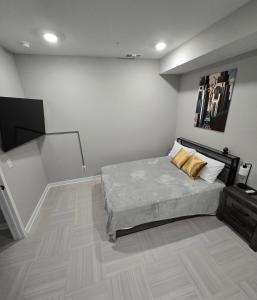 a bedroom with a bed and a flat screen tv at Immaculate Vibes Sunset View Condo in Birmingham +2 photos