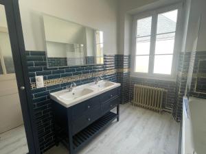 a bathroom with a sink and a mirror at Le Louis d'Or in Beaumont-sur-Sarthe +14 photos