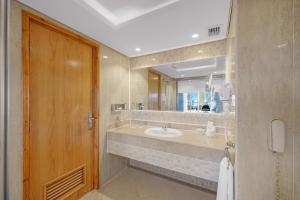 a bathroom with a sink and a large mirror at Grand Oasis Resort in Sharm El Sheikh