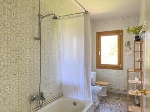 a bathroom with a shower and a tub and a toilet at Casa Lambre in Paderne +37 photos