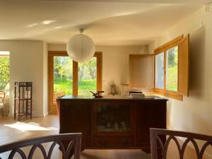 a kitchen with a table and a pendant light at Casa Lambre in Paderne