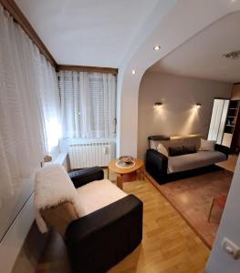 a living room with a couch and a table at Stan na dan bb in Bajina Bašta +3 photos