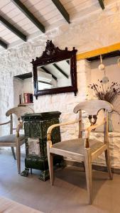 a room with a chair and a mirror and a table at Son Vapur Otel in Gökçeada
