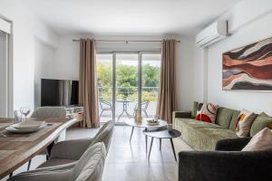 a living room with a couch and a table at Kraken 2-BR Apartment by Makenzy Beach in Larnaca