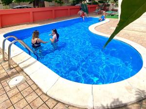 two women are playing in a swimming pool at Hotel Aron Rimini in Rimini