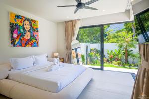a bedroom with a large bed and a large window at Villa Babylon Chaweng in Koh Samui +105 photos