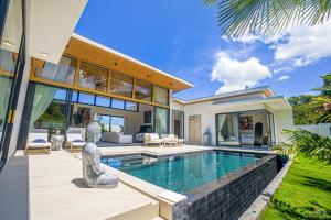 a villa with a swimming pool and a house at Villa Babylon Chaweng in Koh Samui