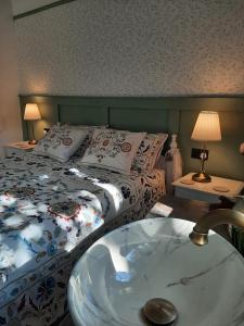a bedroom with a bed with a sink in it at Mulberry Tree Cottage Episkopi Paphos in Episkopi Pafou
