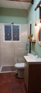 a bathroom with a sink and a toilet and a tub at El Rincón de Ani in Torres