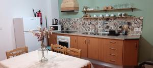 a kitchen with a table with a vase of flowers at El Rincón de Ani in Torres