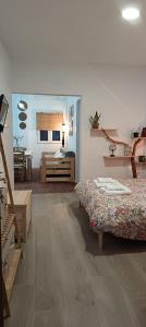 a room with two beds and a room with a bedroom at El Rincón de Ani in Torres