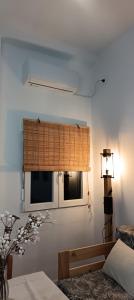 a bedroom with a bed and two windows at El Rincón de Ani in Torres