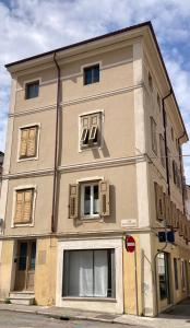 a large building with windows on a city street at Casa Dante in Gradisca dʼIsonzo