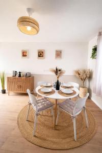 a dining room with a white table and chairs at L'échappée belle, en Champagne in Dormans