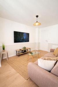 a living room with a couch and a table at L'échappée belle, en Champagne in Dormans