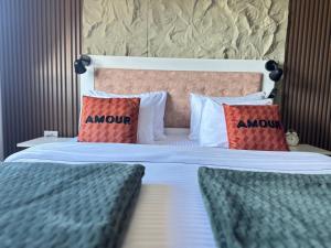 a bedroom with a bed with two pillows on it at Apartman Viktorija in Žabljak