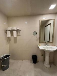 a bathroom with a sink and a mirror at Amazinn Hotel in Lonavala +20 photos