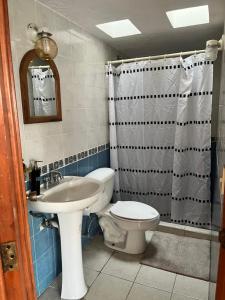 a bathroom with a white toilet and a sink at Casa Bohemia in Ciudad Guzmán +20 photos