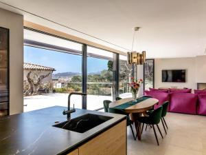 a kitchen and living room with a large window at Lux CostaBravaSi in Platja d'Aro