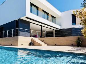 a house with a swimming pool in front of it at Lux CostaBravaSi in Platja d'Aro