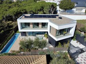 an aerial view of a house with a swimming pool at Lux CostaBravaSi in Platja d'Aro