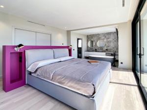 a bedroom with a large purple bed and a bathroom at Lux CostaBravaSi in Platja d'Aro +32 photos