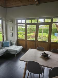 a living room with a table and a couch at B&B Chocla-dort in Koekelare