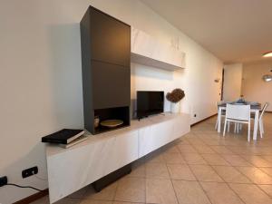 a living room with a large entertainment center with a television at Casa Chiaretto Piscina e Relax nel cuore di Moniga in Moniga