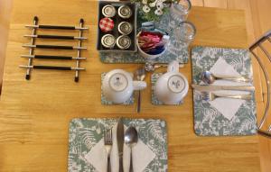 a table with plates and utensils on a table at Yaxham Mill in East Dereham