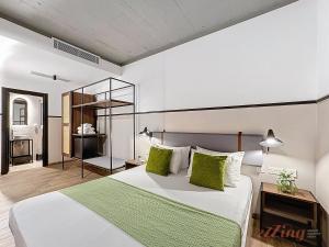 a bedroom with a large white bed with green pillows at South 32 Hotel by Zzzing in Birżebbuġa +65 photos