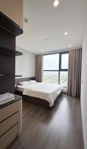 a bedroom with two beds and a large window at The Ruby Hạ Long in Ha Long +7 photos