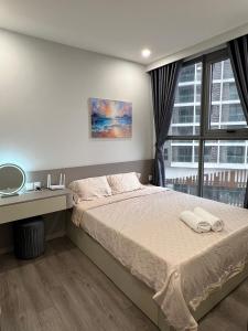 a bedroom with a bed and a large window at The Ruby Hạ Long in Ha Long