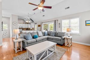 a living room with a couch and a table at Rising Sun OBX in Corolla