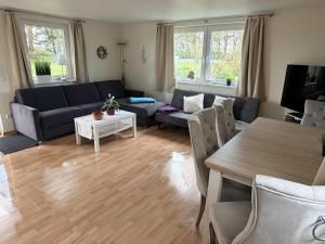 a living room with a couch and a table at Gästehaus Rosenkamp in Scharbeutz +36 photos