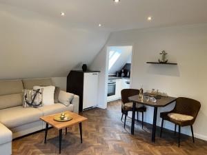 a living room with a couch and a table at Haus Larum App. 6 in Scharbeutz