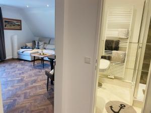 a living room with a couch and a table at Haus Larum App. 6 in Scharbeutz +45 photos