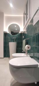 a bathroom with a white toilet and a sink at Nest Scilla in Scilla +28 photos