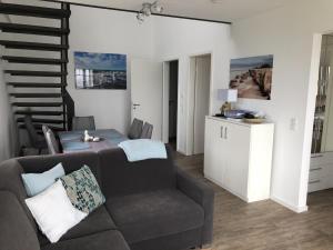a living room with a couch and a table at Meersicht Haffkrug in Haffkrug