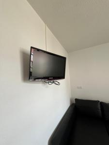 a flat screen tv hanging on a wall at Studio Climatisé au centre ville in Digoin