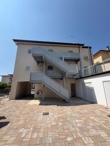 a building with stairs on the side of it at Hillside House Sant'Andrea in Vittorio Veneto