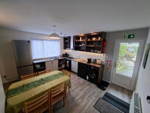 a kitchen with a table and a dining room at Derryhick Escape in Crillaun