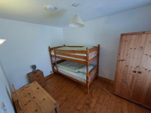 a room with two bunk beds and wooden floors at Derryhick Escape in Crillaun