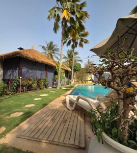 a villa with a swimming pool and a resort at Jardin d'Afrique, Saly in Saly Portudal