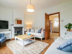 a living room with a couch and a table at Lumford Mill Cottage in Bakewell