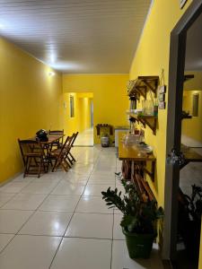 a kitchen and dining room with a table and chairs at pousada palmeiras bhs in Barreirinhas