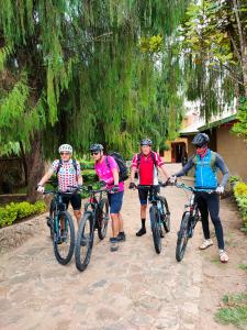 a group of people riding bikes down a dirt road at Bright Michelle Homestay in Lushoto