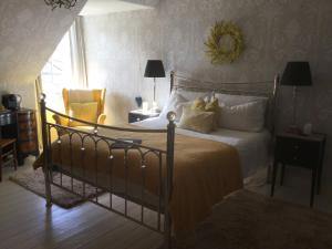a bedroom with a large bed with white pillows at Nether Dallachy Farmhouse in Banff