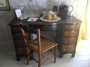 a desk with a chair and a coffee maker on it at Nether Dallachy Farmhouse in Banff
