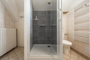 a shower with a glass door in a bathroom at À 300m du virage de Mulsanne - Maison 8 pers avec extérieur et parking in Mulsanne +26 photos
