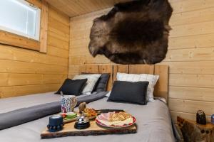 a bedroom with a bed with a tray of food on it at Tupa Lodge by The Guide Father in Rovaniemi